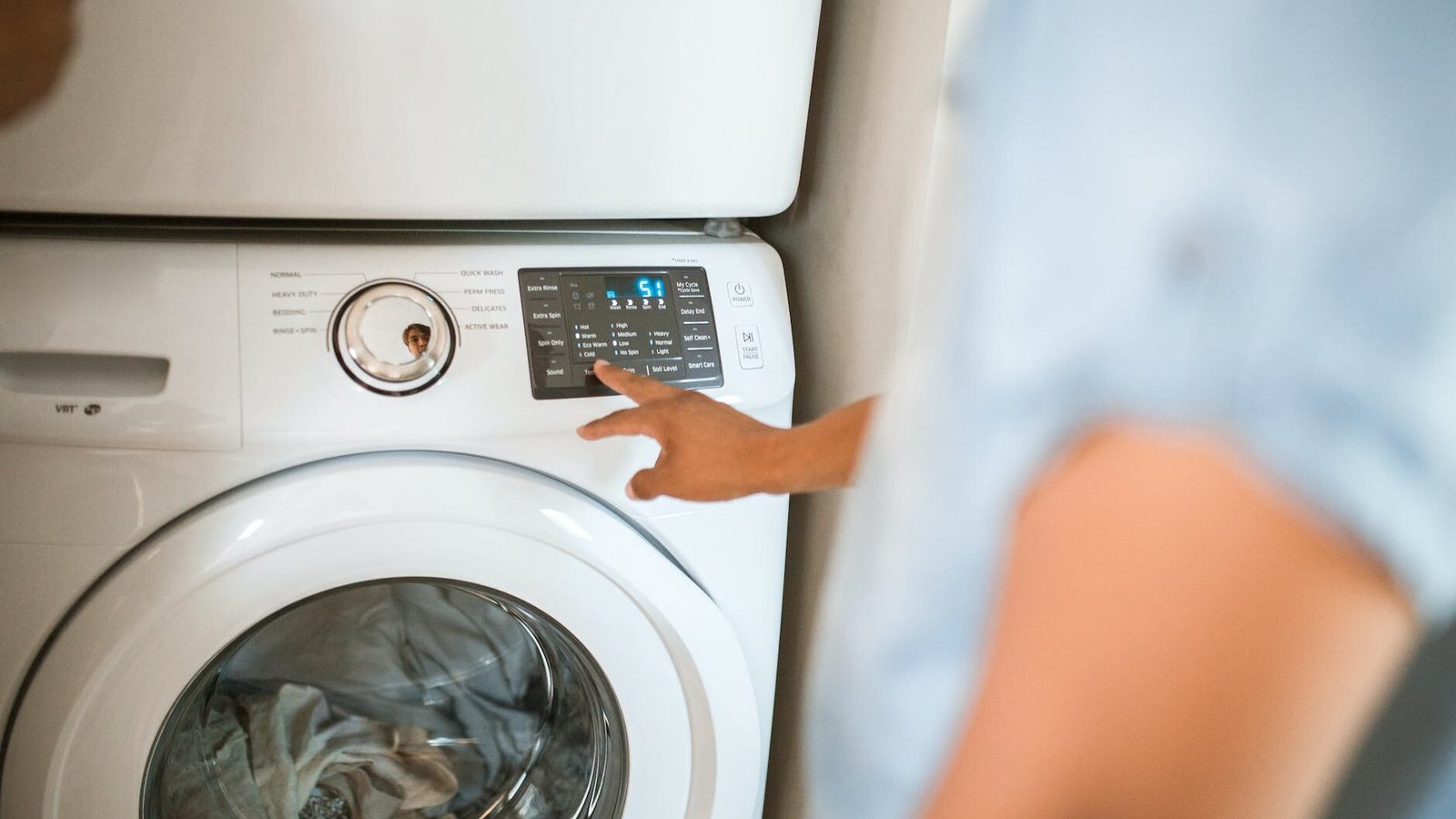person using washing machine to unlock the smart feature
